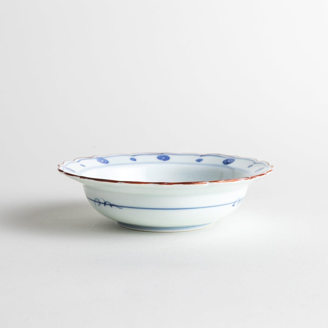 A white ceramic bowl with a blue floral design inside.