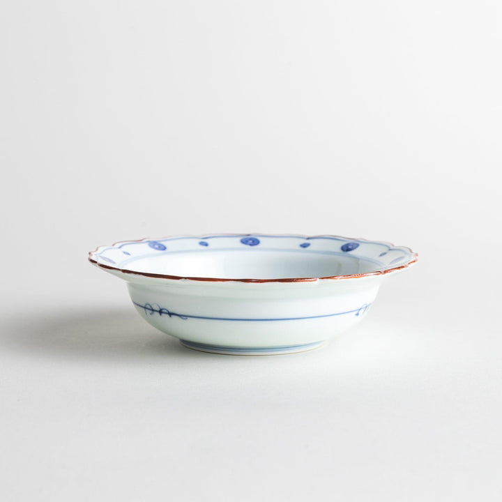 A white ceramic bowl with a blue floral design inside.