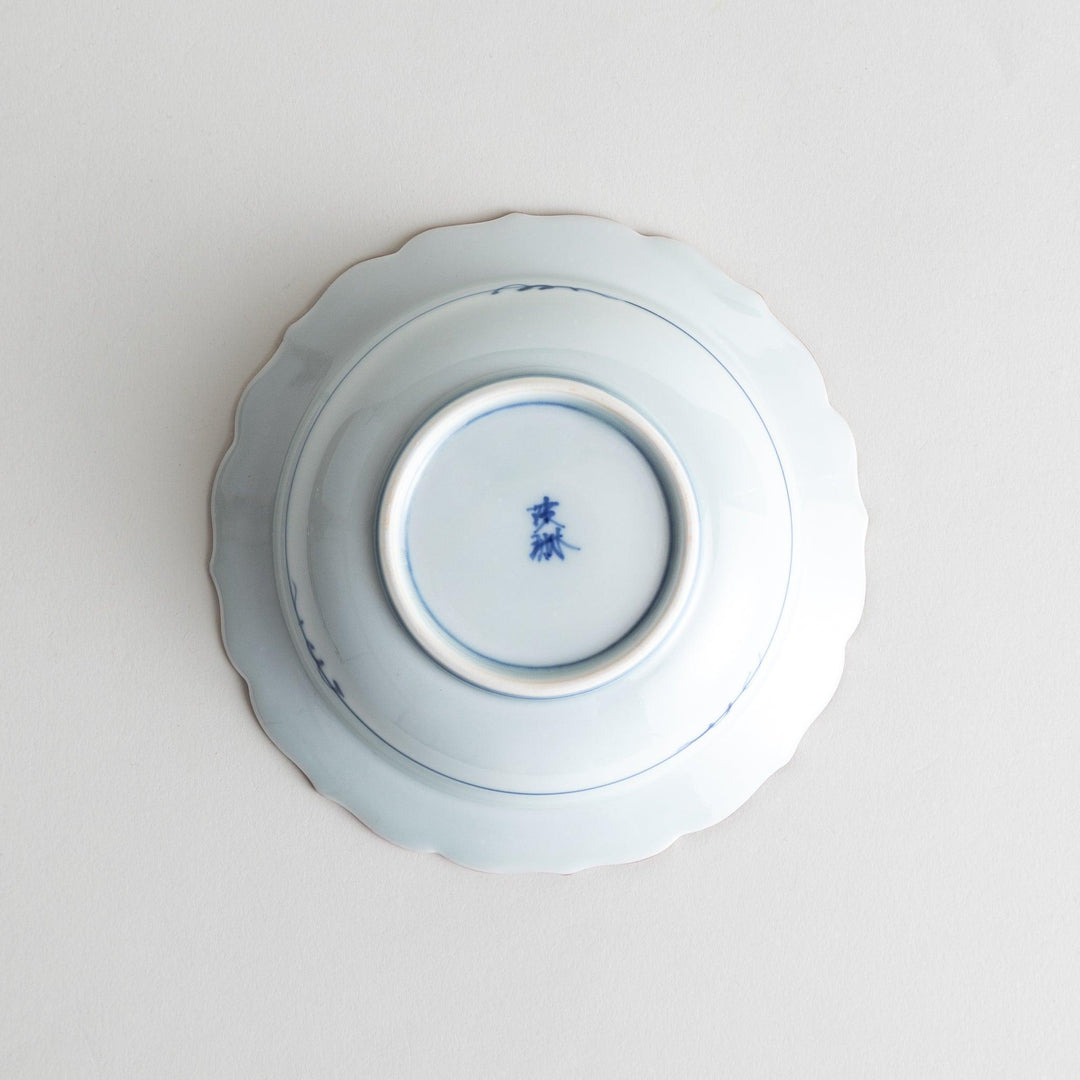 A white ceramic bowl with a blue floral design inside.