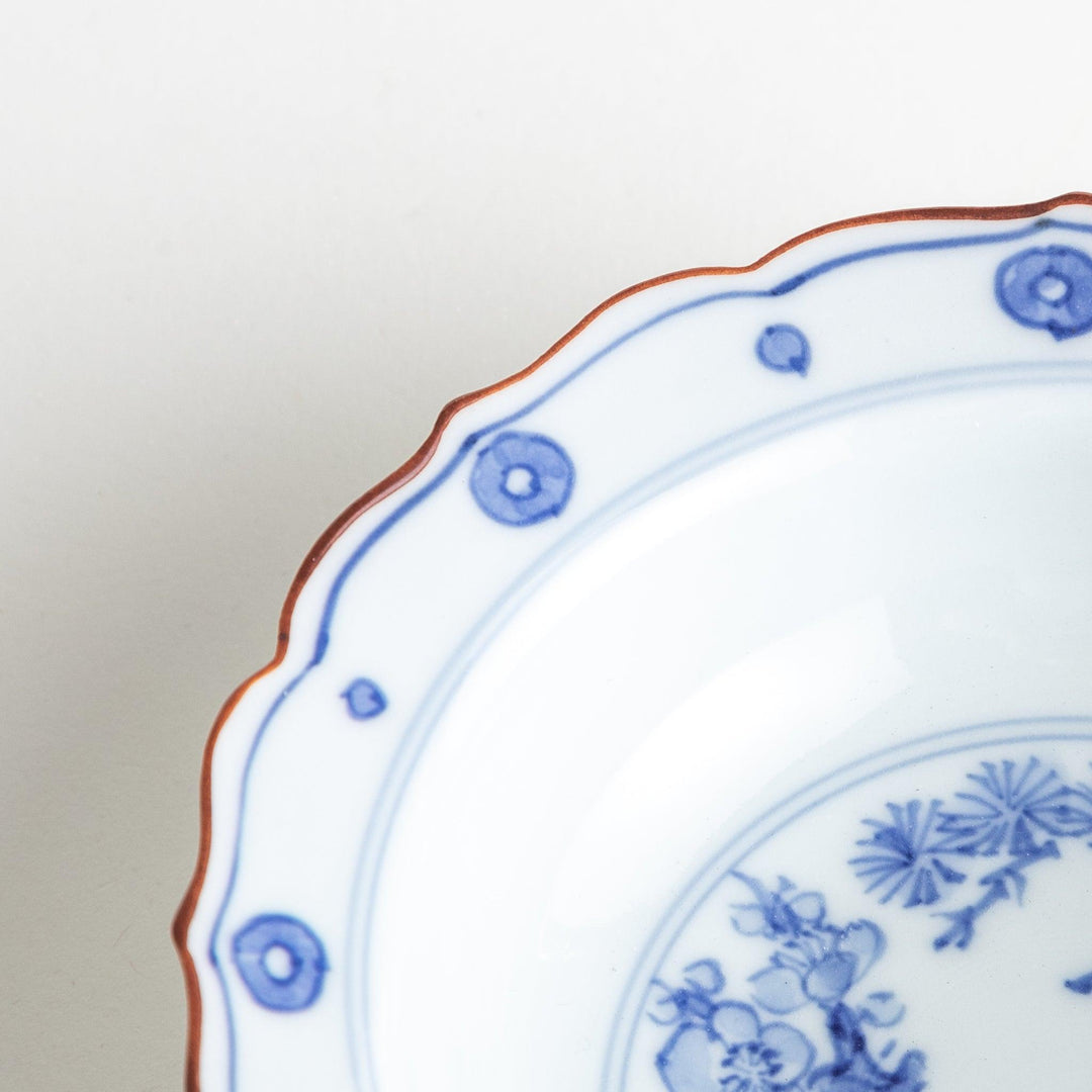 A white ceramic bowl with a blue floral design inside.