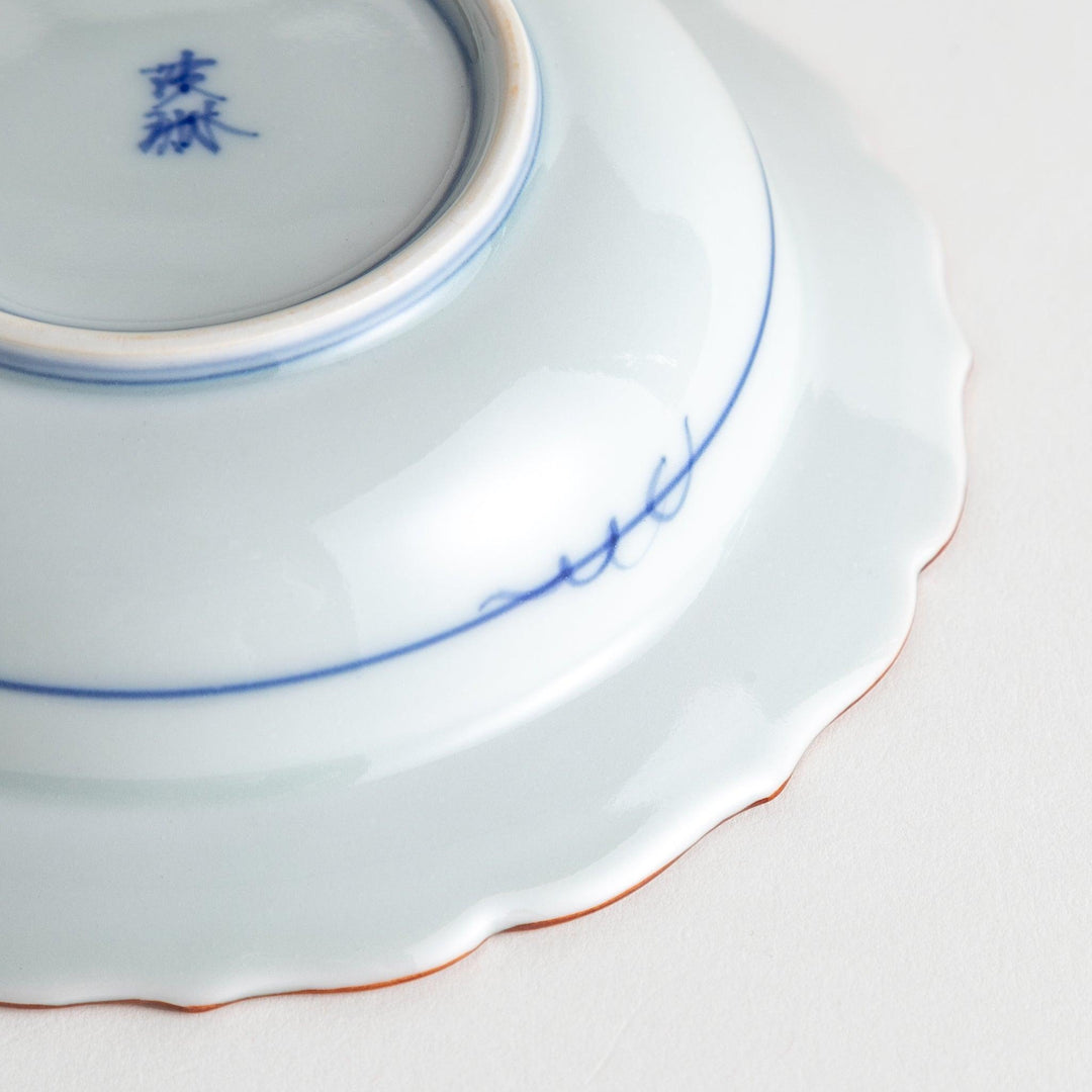 A white ceramic bowl with a blue floral design inside.