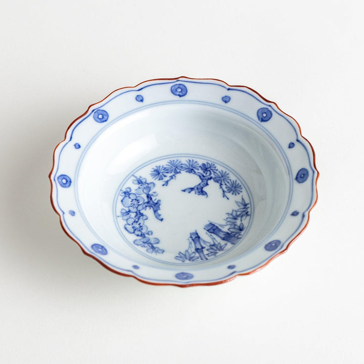 A white ceramic bowl with a blue floral design inside.