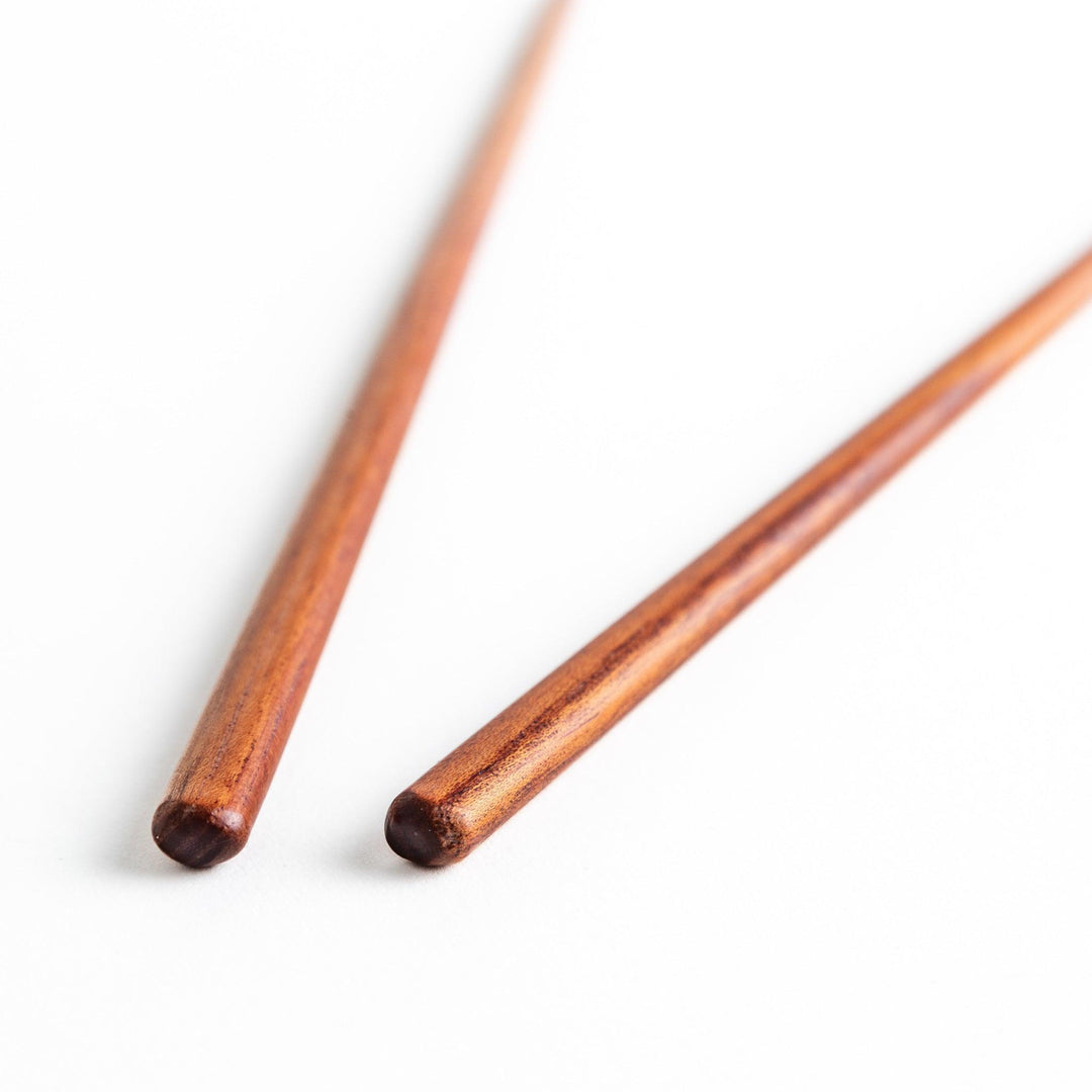 Three pairs of natural zelkova wood chopsticks, each with a different geometric shape—triangle, hexagon, and round.