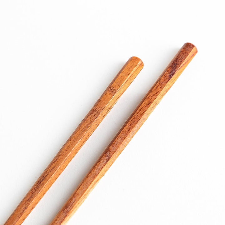 Three pairs of natural zelkova wood chopsticks, each with a different geometric shape—triangle, hexagon, and round.