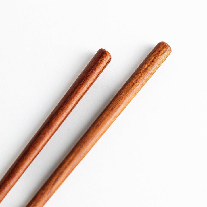 Three pairs of natural zelkova wood chopsticks, each with a different geometric shape—triangle, hexagon, and round.