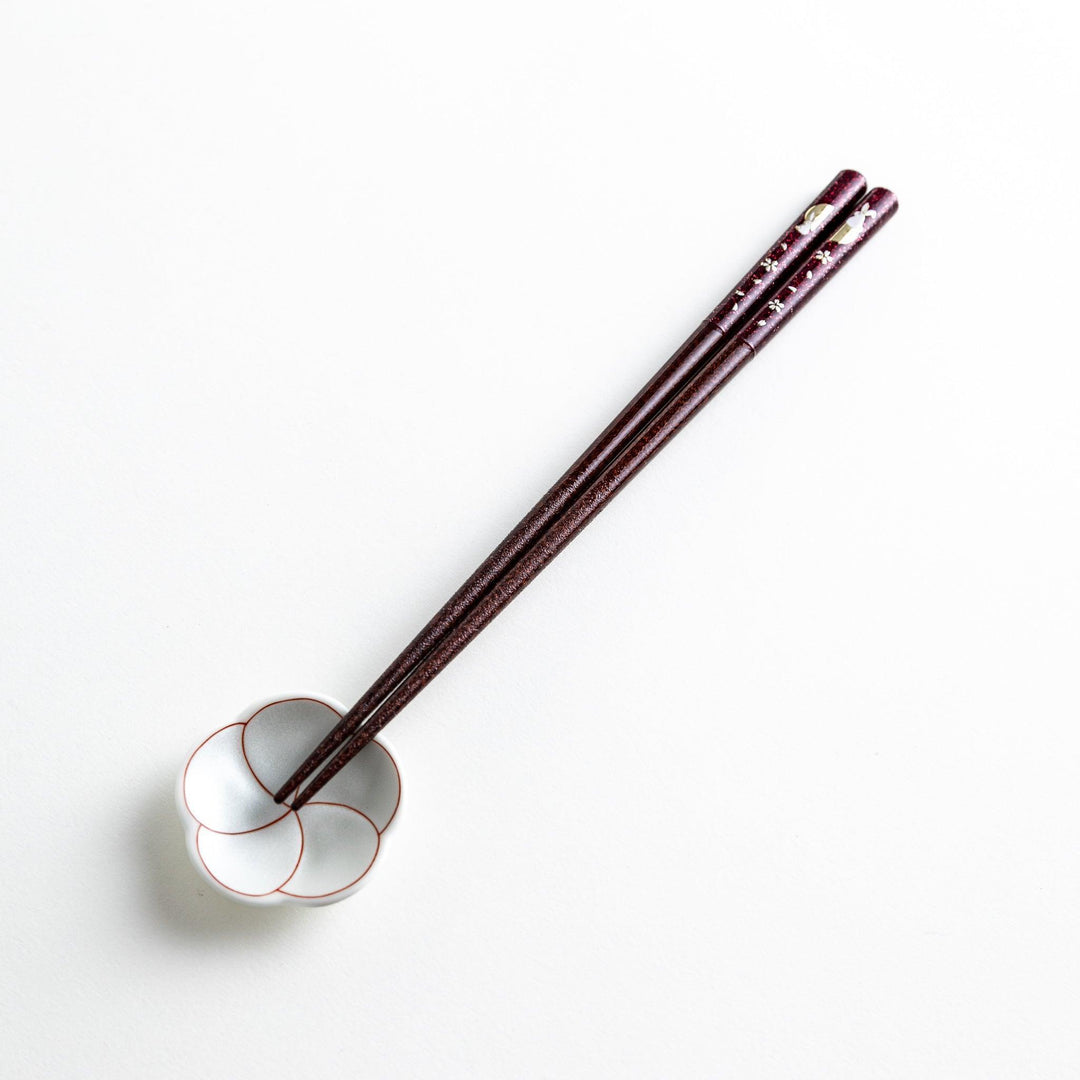 A pair of lacquered chopsticks adorned with floral patterns and rabbit. Available in purple or red.