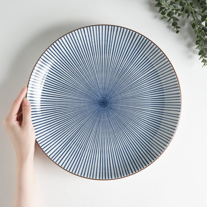 An serving plate displaying a blue and white lattice pattern, adding a modern touch to a traditional design.