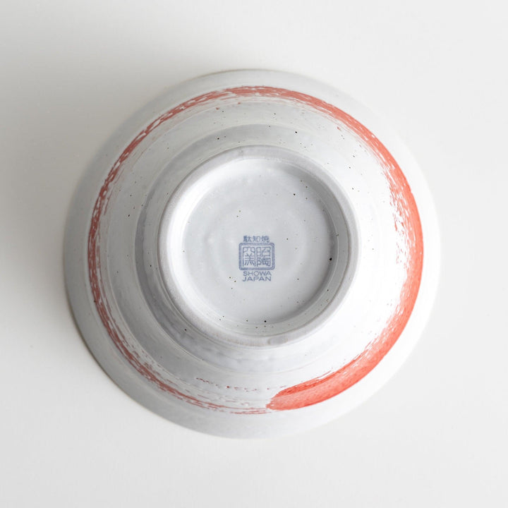 A white ramen bowl with a wide red brushstroke across its exterior.