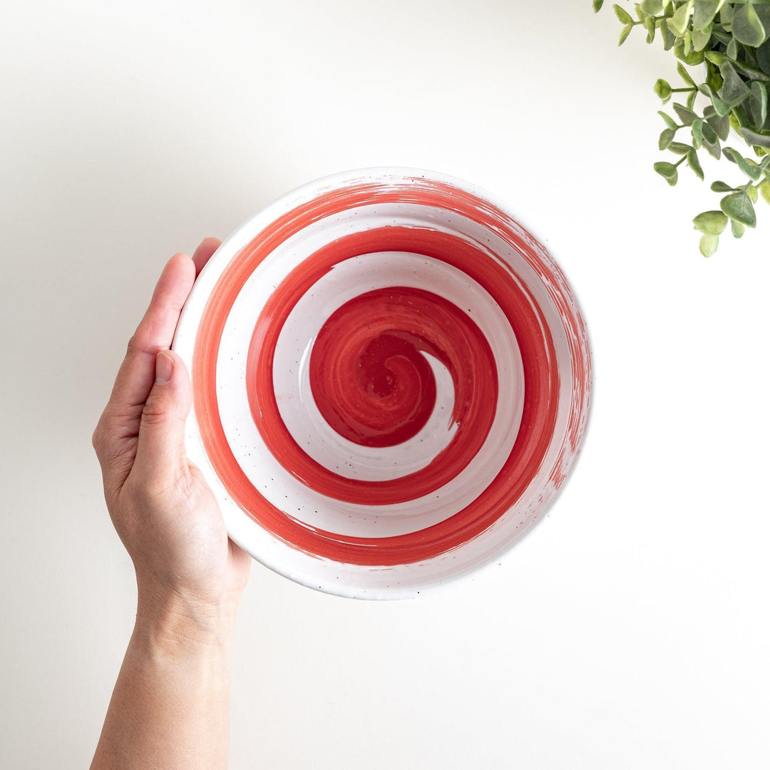 A white ramen bowl with a wide red brushstroke across its exterior.