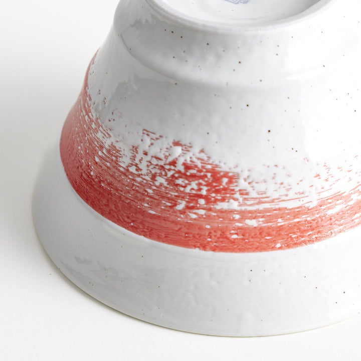 A white ramen bowl with a wide red brushstroke across its exterior.