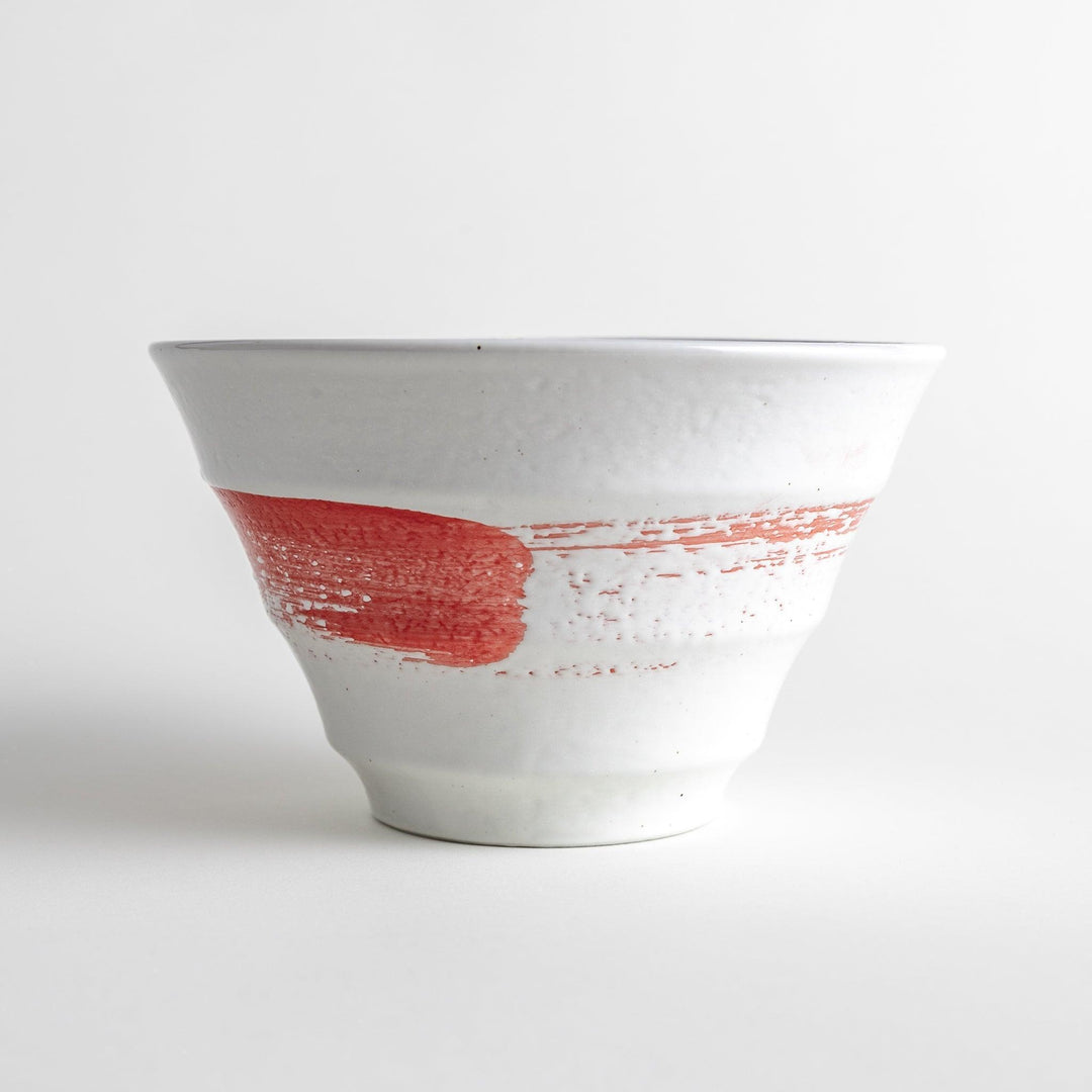 A white ramen bowl with a wide red brushstroke across its exterior.