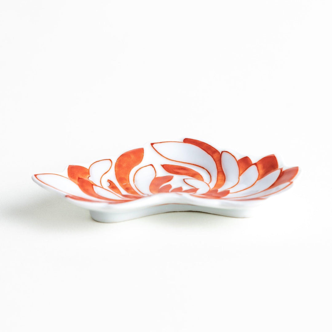 Orange chrysanthemum-shaped plate with gold outlining
