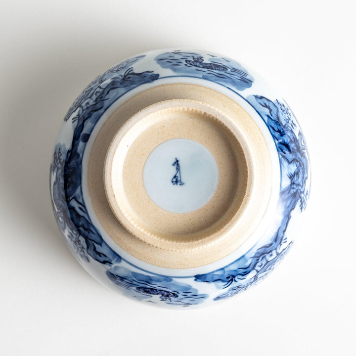 A bowl featuring a traditional blue and white landscape design.