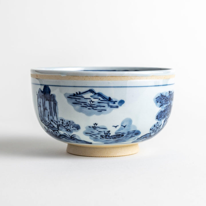 A bowl featuring a traditional blue and white landscape design.