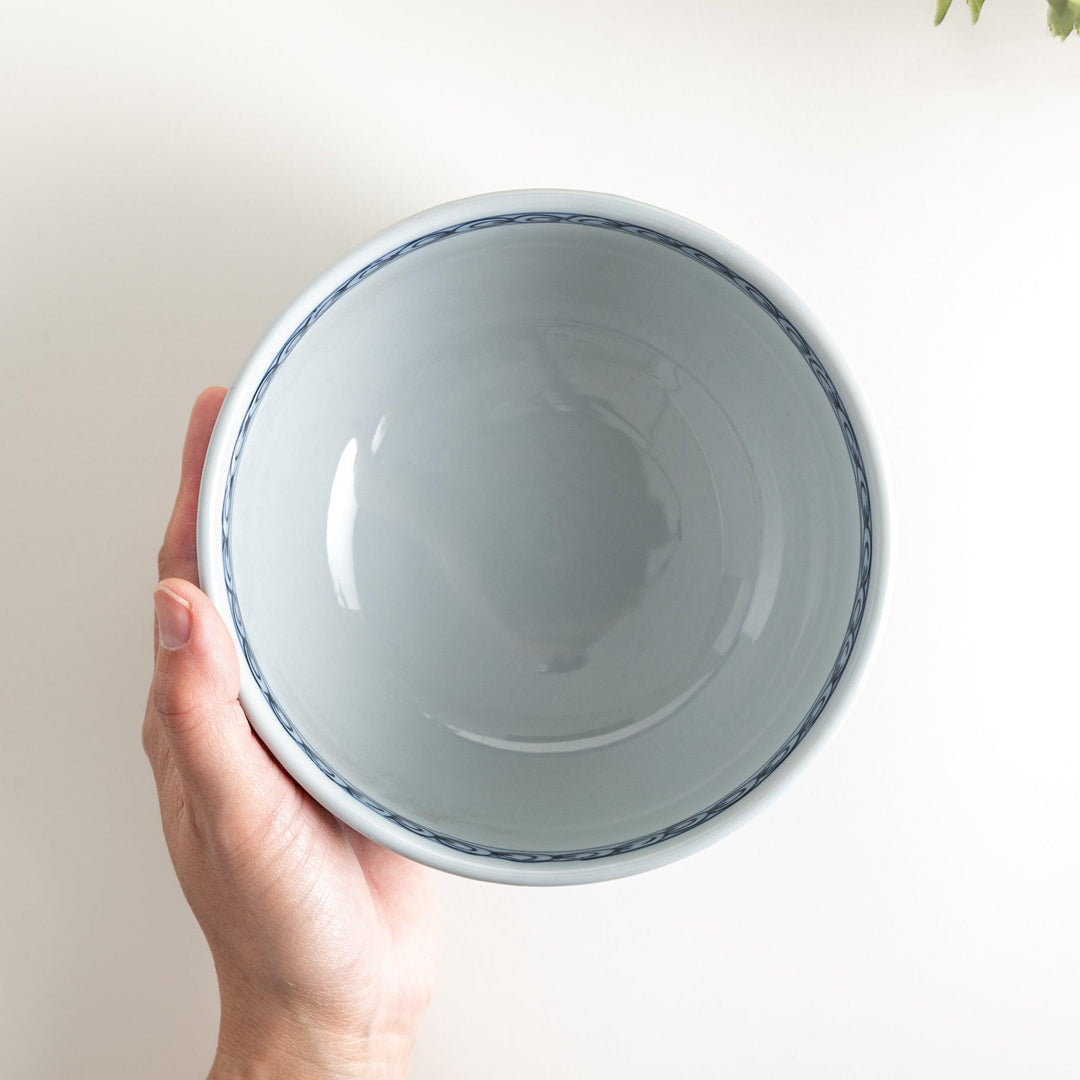 A bowl featuring a traditional blue and white landscape design.