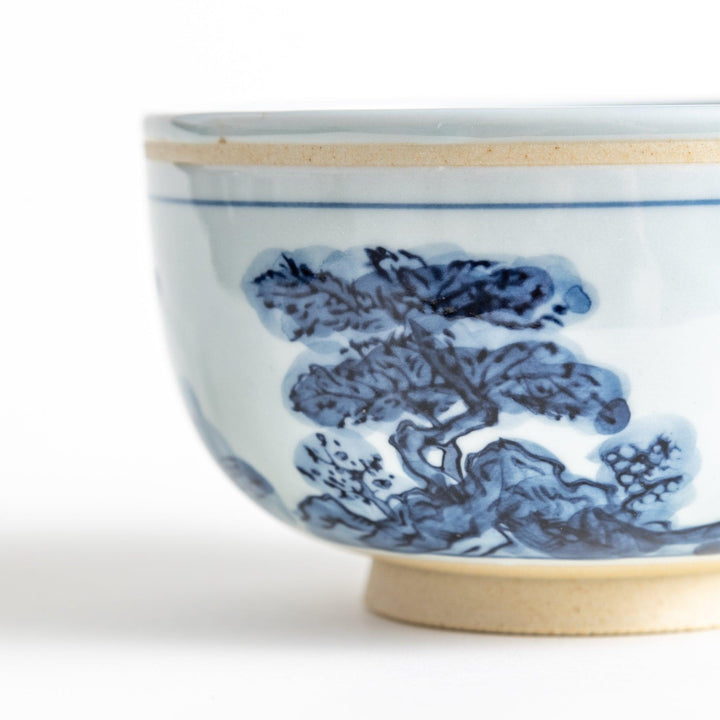 A bowl featuring a traditional blue and white landscape design.