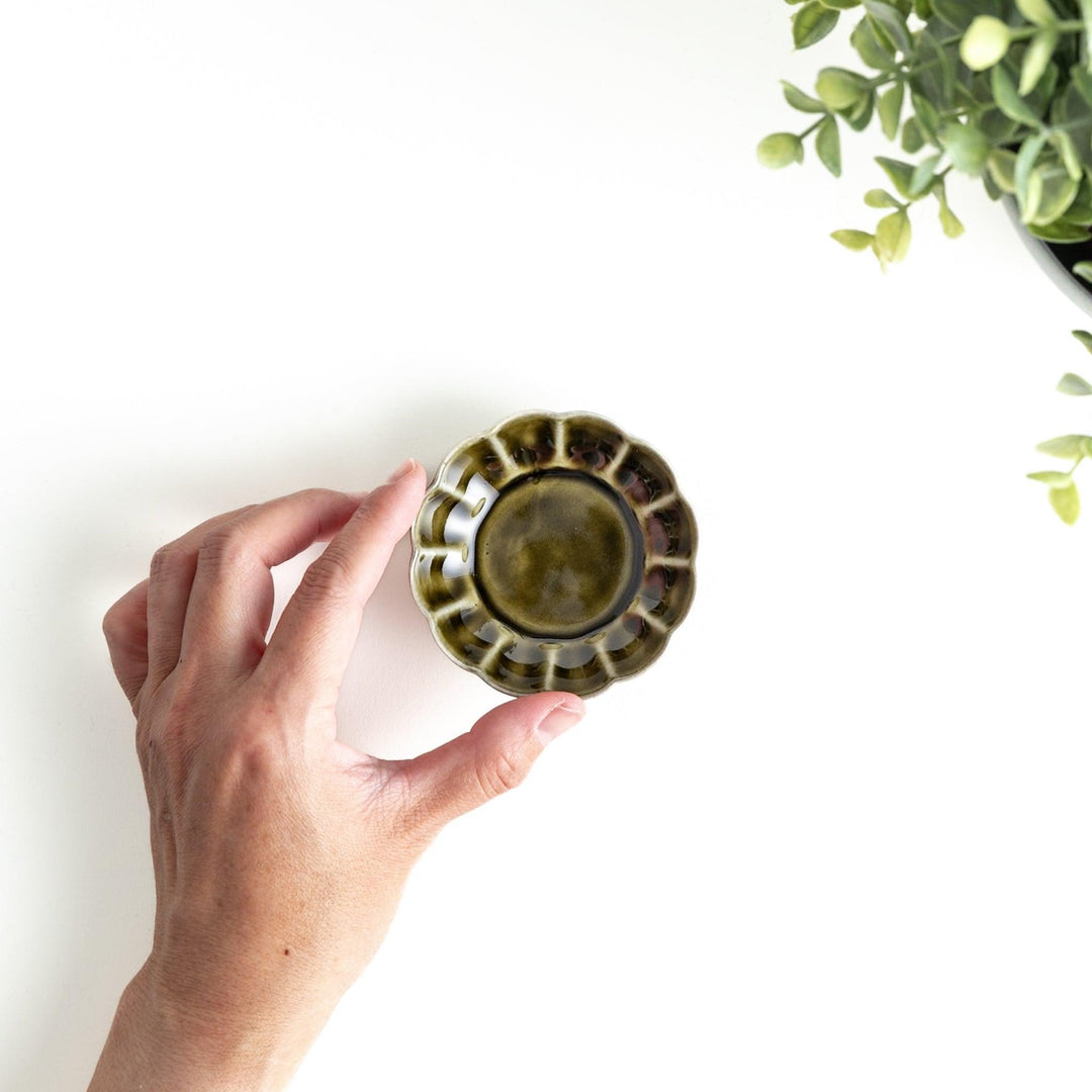 Dessert bowl with scalloped edges and a glossy dark brown or olive color finish.