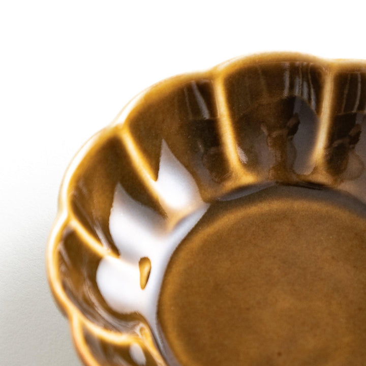 Dessert bowl with scalloped edges and a glossy dark brown or olive color finish.