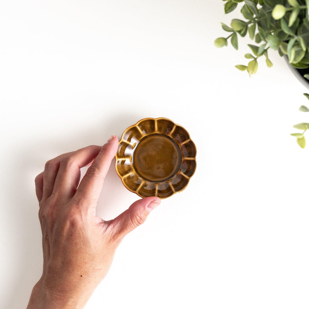 Dessert bowl with scalloped edges and a glossy dark brown or olive color finish.