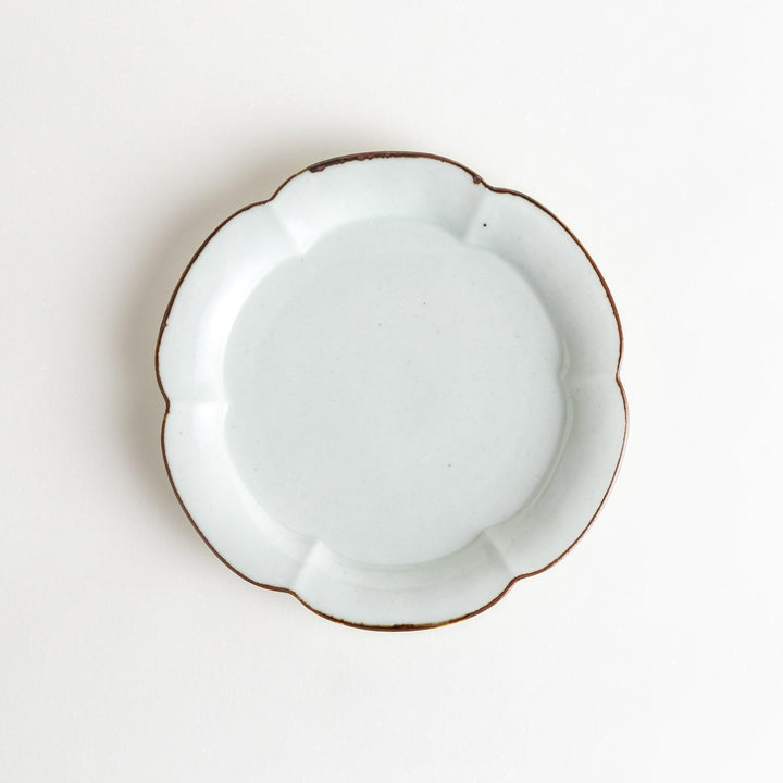 Earthy tones of olive, caramel, or off-white salad plate, with a soft, rounded shape and subtle color variations.