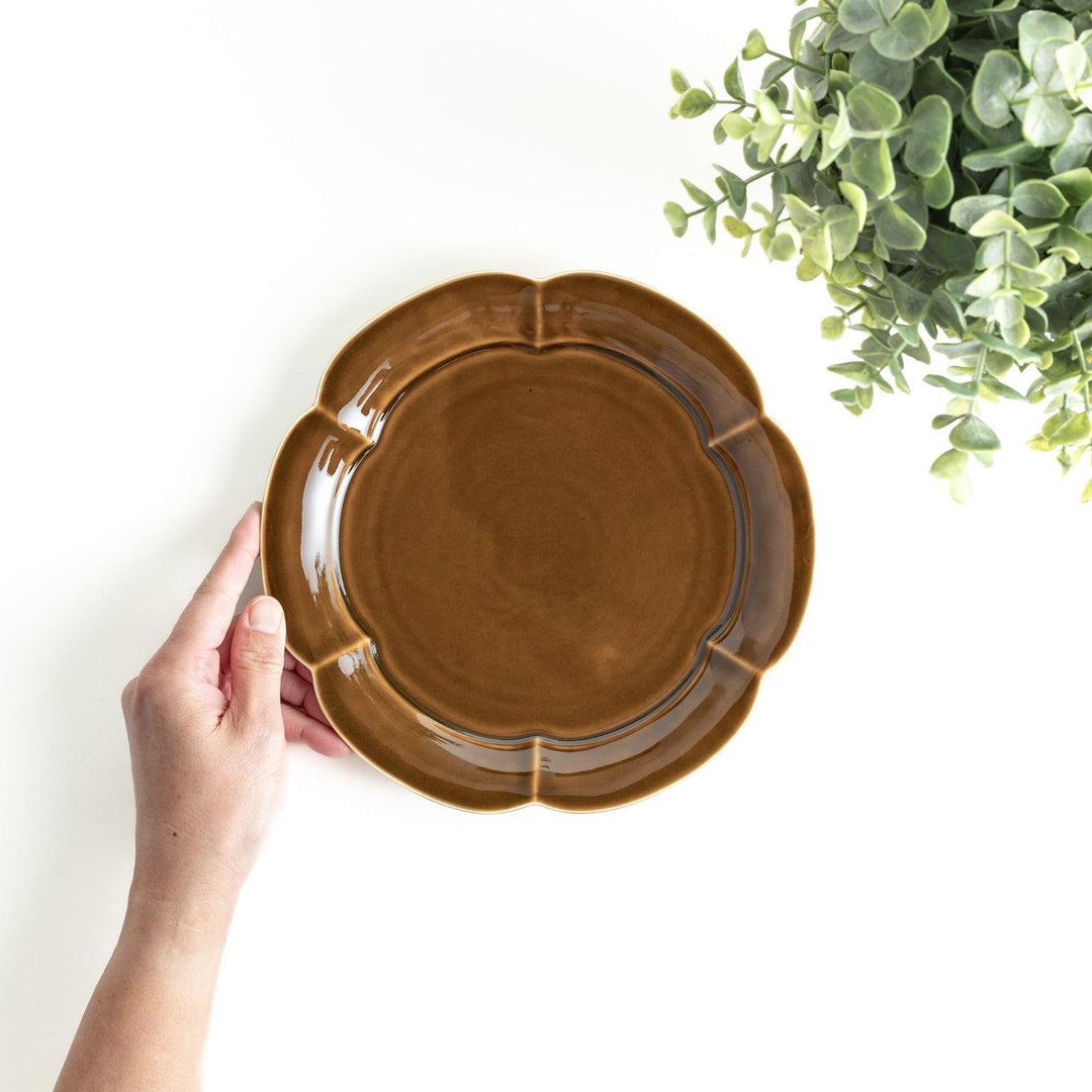 Earthy tones of olive, caramel, or off-white salad plate, with a soft, rounded shape and subtle color variations.