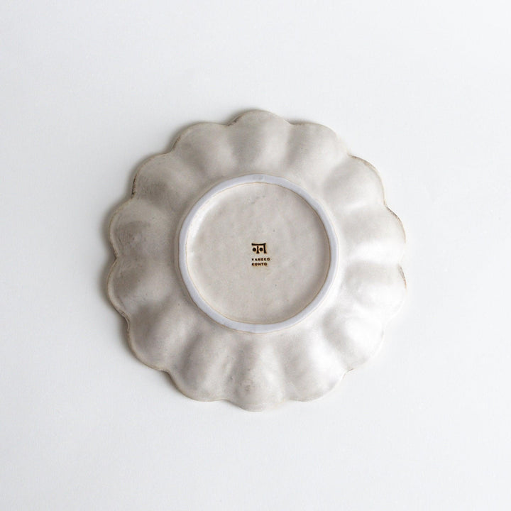 White ceramic salad plate with petal-like, scalloped edges, available in black and white.