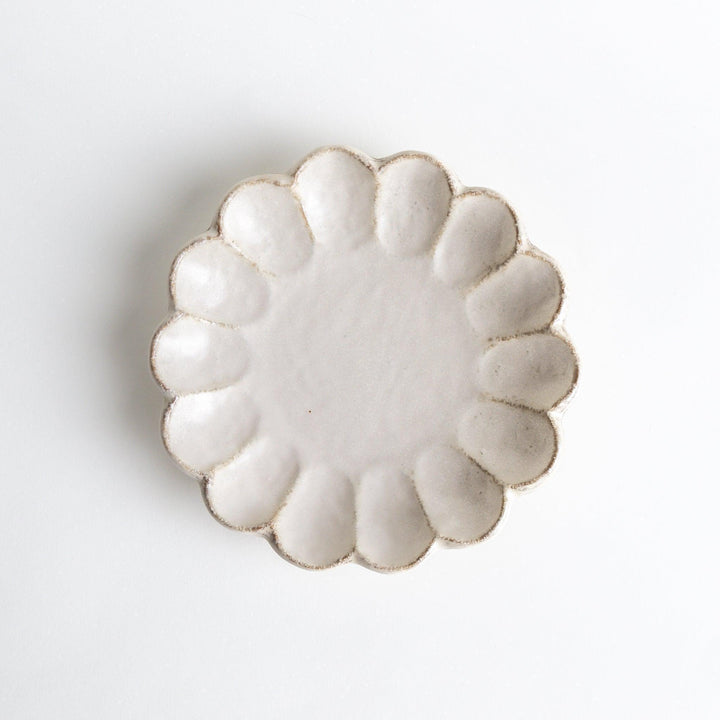 White ceramic salad plate with petal-like, scalloped edges, available in black and white.