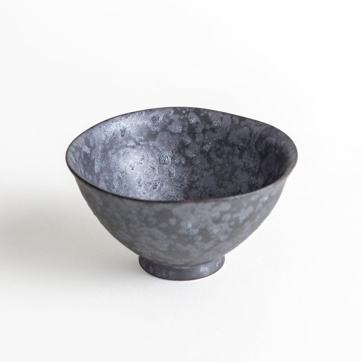 Matte ceramic rice bowls, one in black and the other in white, with a simple, elegant design.