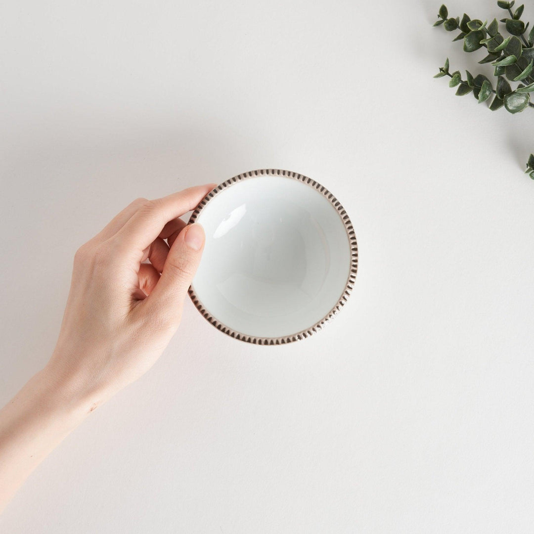 A round white dessert bowl with a rustic scallop-edged border. The border comes in blue, brown, and olive.