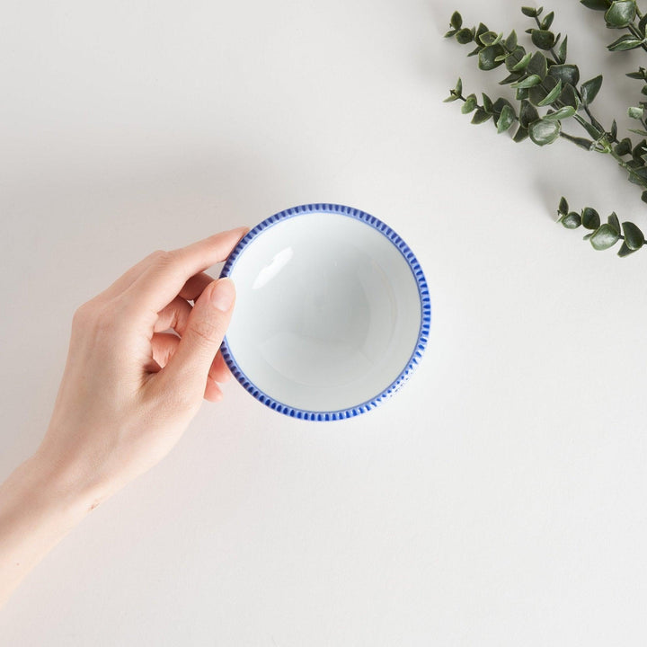 A round white dessert bowl with a rustic scallop-edged border. The border comes in blue, brown, and olive.