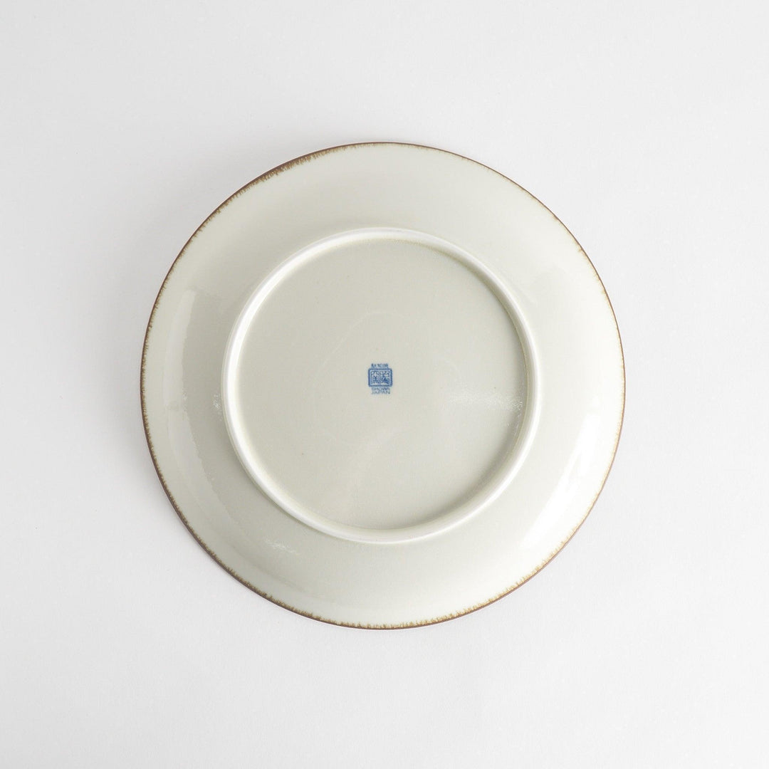 A round serving plate featuring a striking blue radial burst design from the center.