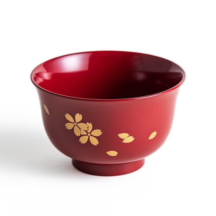 Traditional red lacquer bowl with gold cherry blossom motif, featuring a glossy finish.