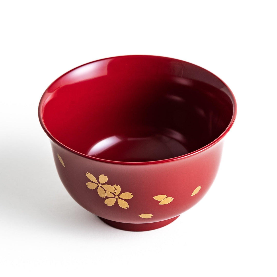 Traditional red lacquer bowl with gold cherry blossom motif, featuring a glossy finish.