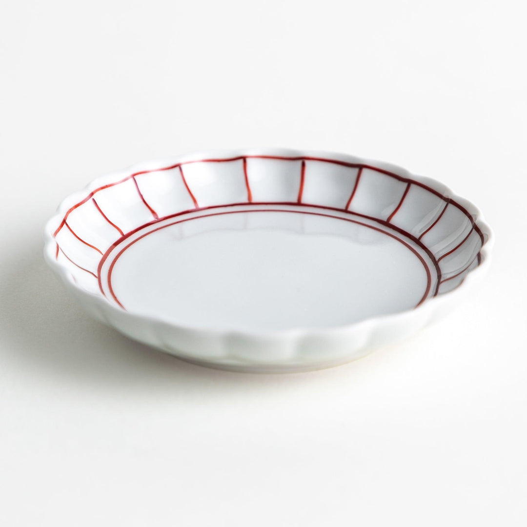 White sauce dish with scalloped edges, outlined in a thin blue or red line.