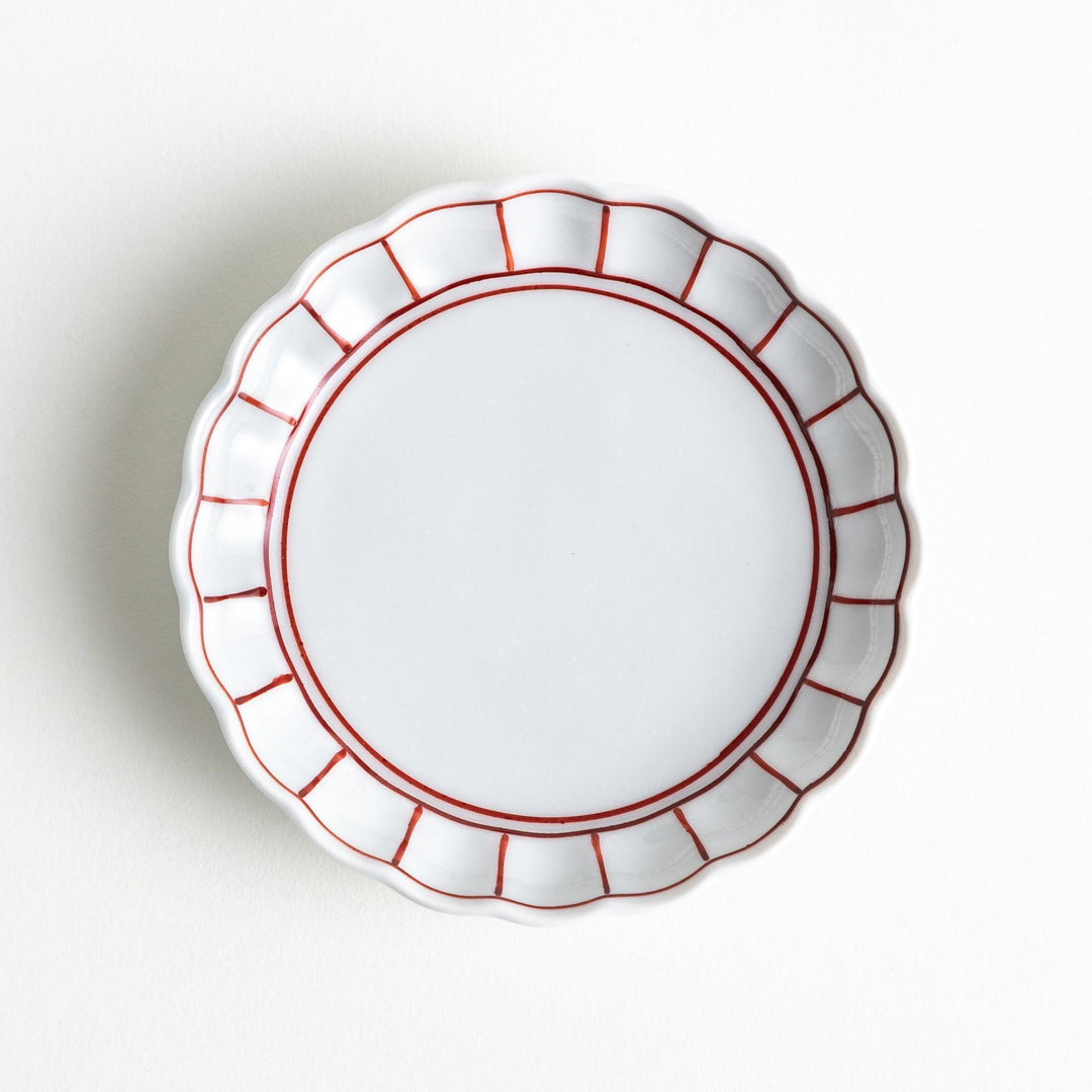 White sauce dish with scalloped edges, outlined in a thin blue or red line.