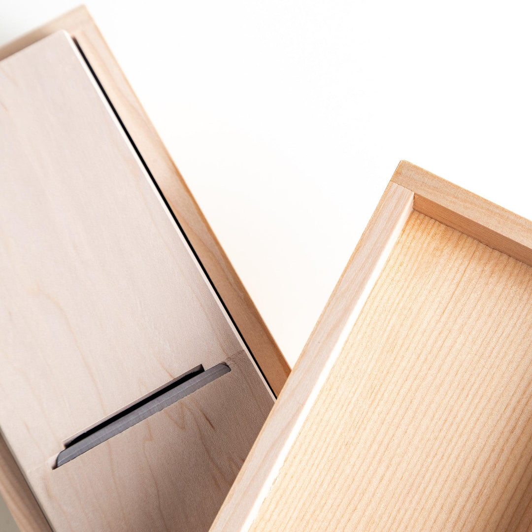 A small wooden box with a sliding drawer and lid, designed for shaving katsuobushi (dried bonito), with a colorful packaging box featuring traditional Japanese artwork.