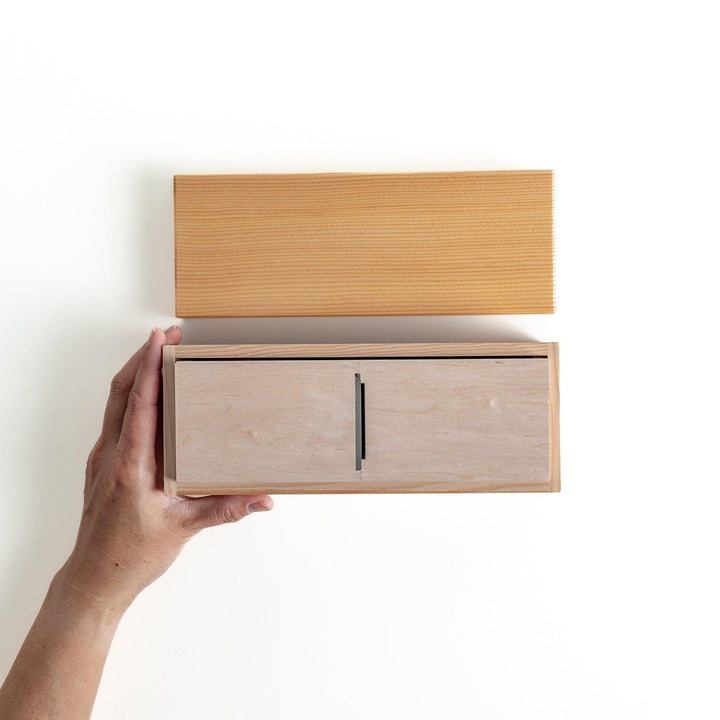 A small wooden box with a sliding drawer and lid, designed for shaving katsuobushi (dried bonito), with a colorful packaging box featuring traditional Japanese artwork.