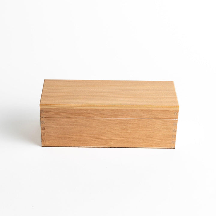 A small wooden box with a sliding drawer and lid, designed for shaving katsuobushi (dried bonito), with a colorful packaging box featuring traditional Japanese artwork.