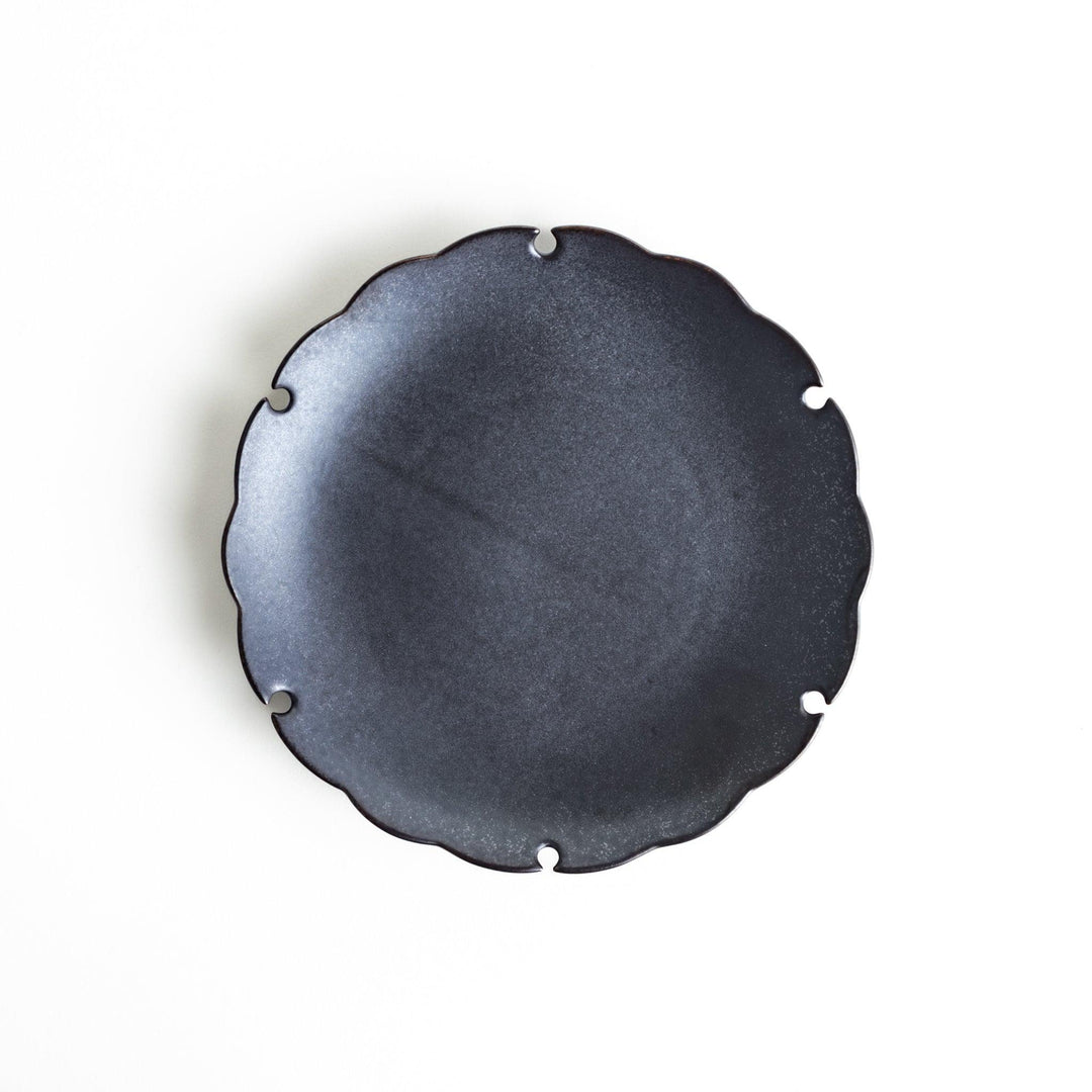 Ceramic dessert plates with scalloped edges, available in black and white.