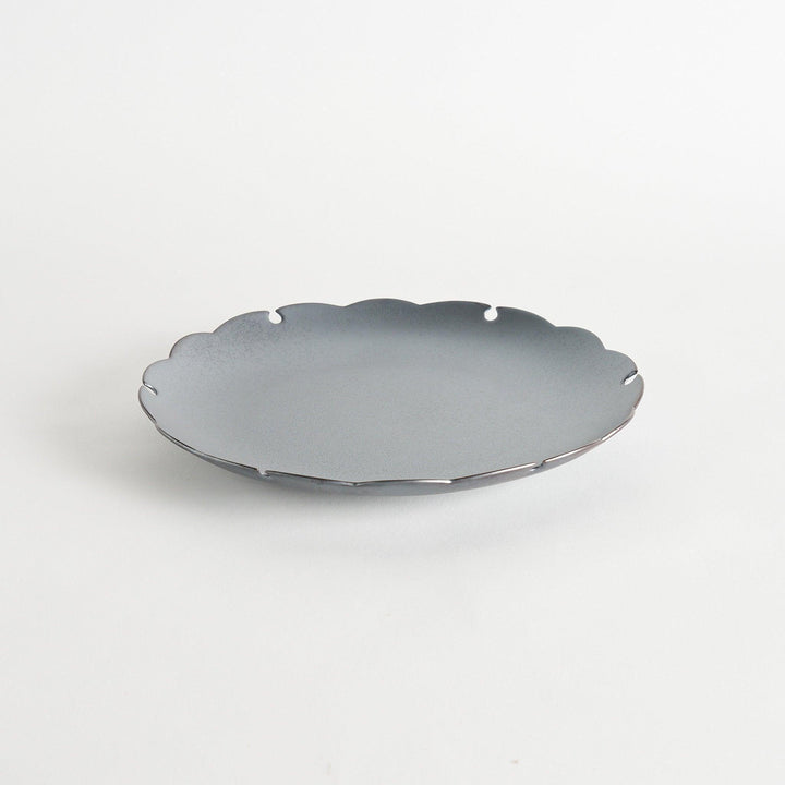 Ceramic dinner plates with scalloped edges, available in black and white.