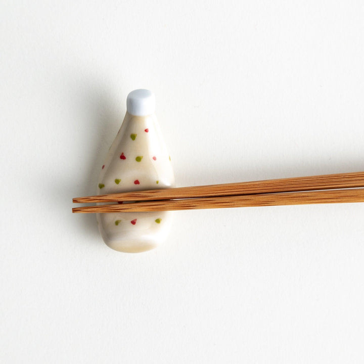 A ceramic chopstick rest resembling a tartar sauce bottle.