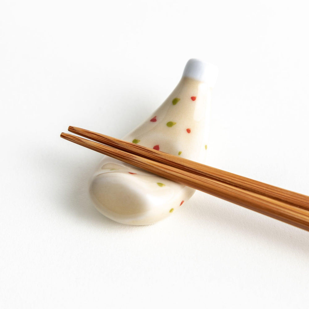 A ceramic chopstick rest resembling a tartar sauce bottle.