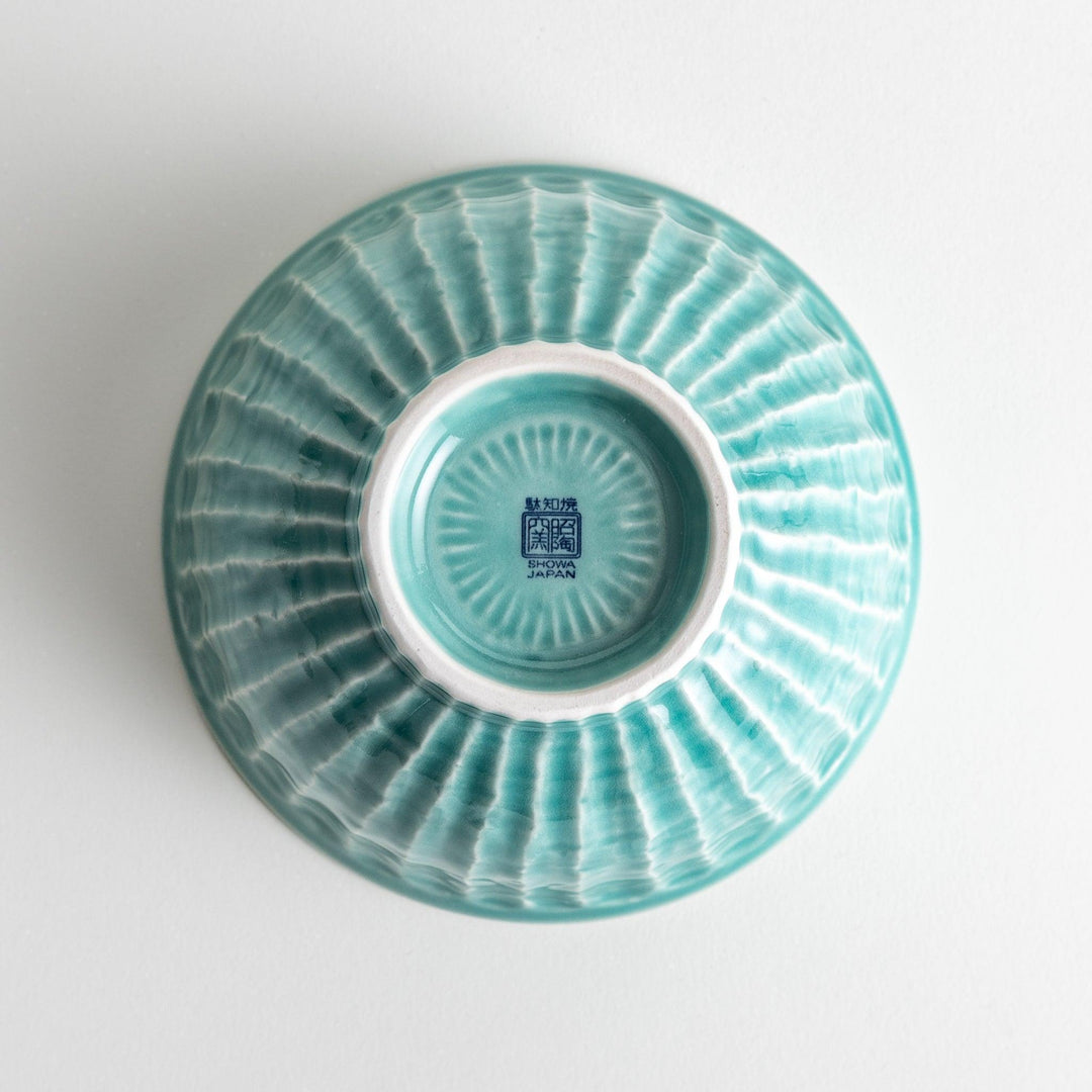 A light turquoise ceramic rice bowl with a natural, rustic texture and a ribbed design.