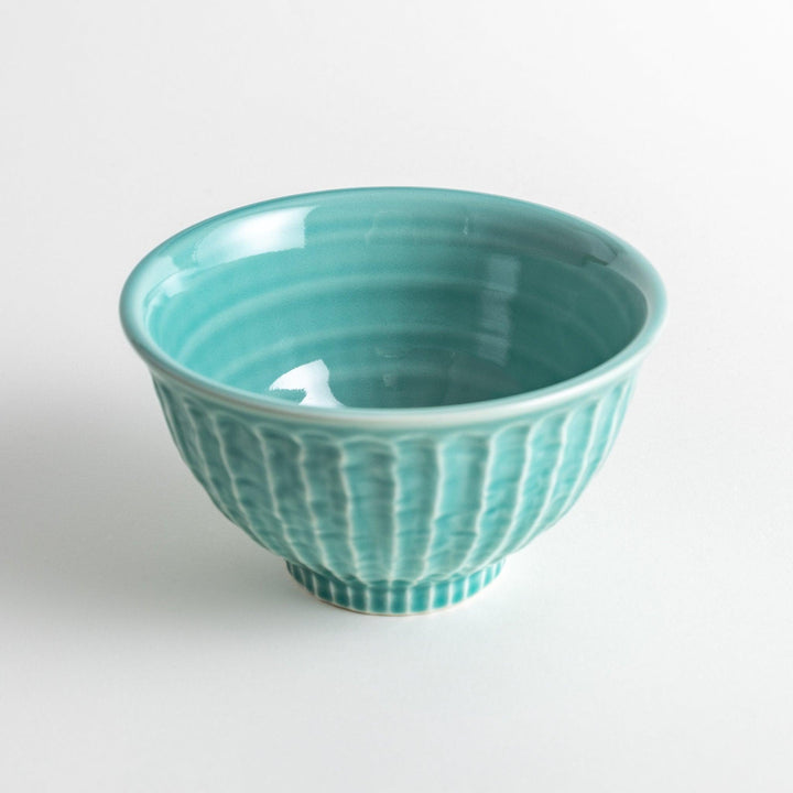 A light turquoise ceramic rice bowl with a natural, rustic texture and a ribbed design.