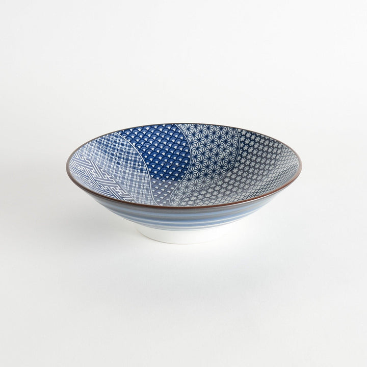 A bowl with a deep blue exterior and a segmented interior featuring various traditional blue patterns.