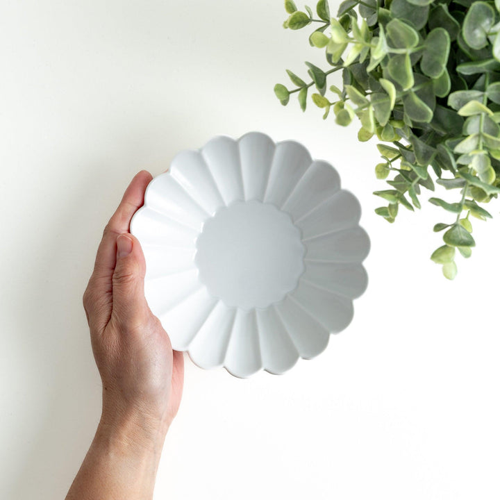 A white ceramic bowl featuring a fluted design.