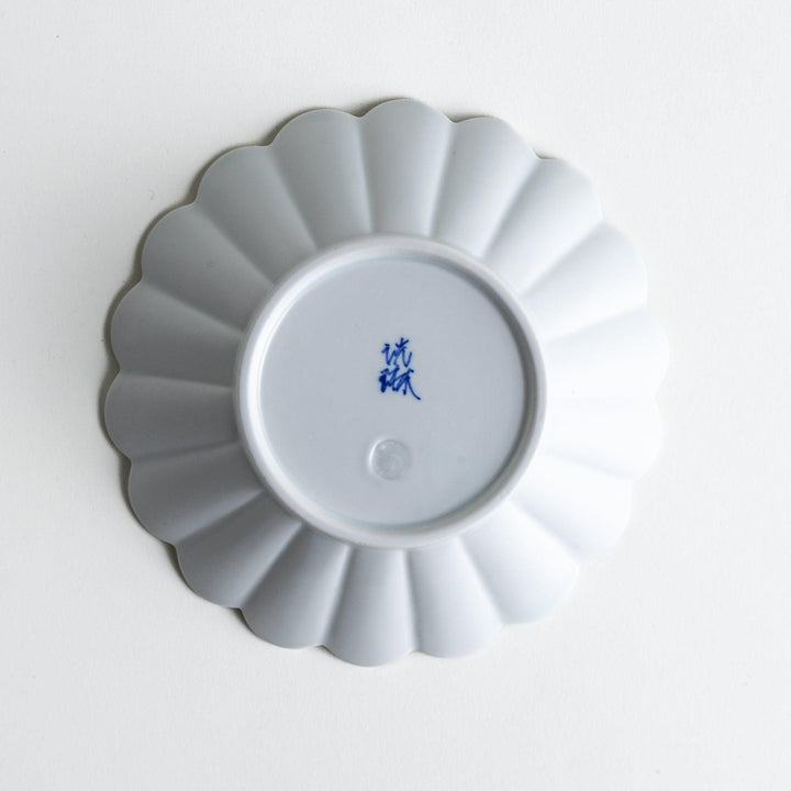 A white ceramic bowl featuring a fluted design.