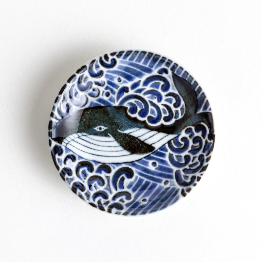 A small sauce dish with a detailed blue and white whale design, perfect for condiments.