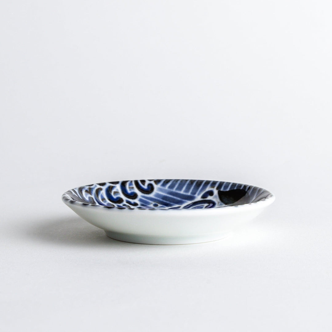 A small sauce dish with a detailed blue and white whale design, perfect for condiments.