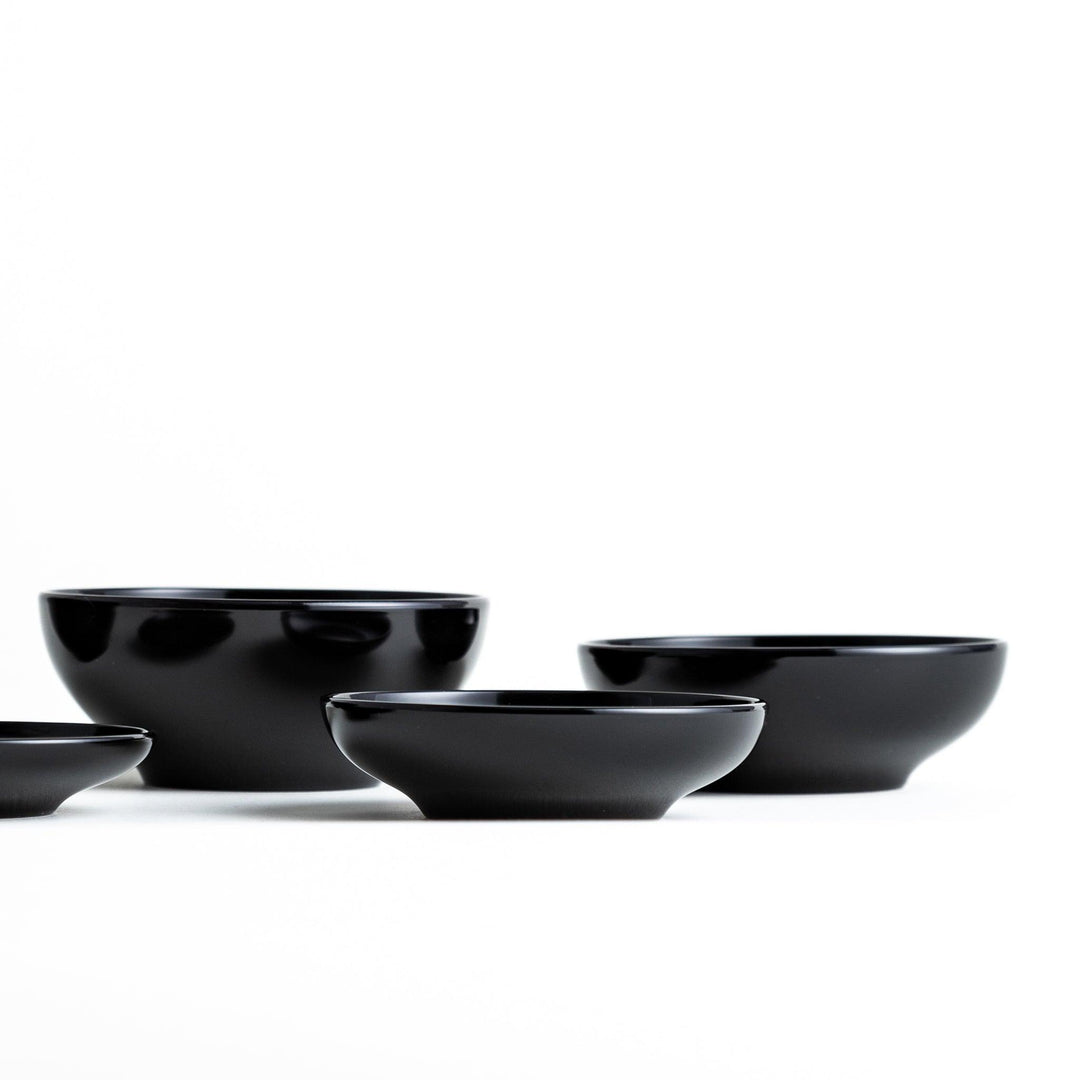 A set of five nested lacquer bowls, commonly used in oryoki meals, representing minimalism and mindfulness. Available in black or red.